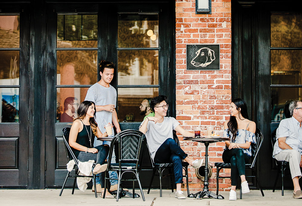 students sitting at a table outside a restaurant